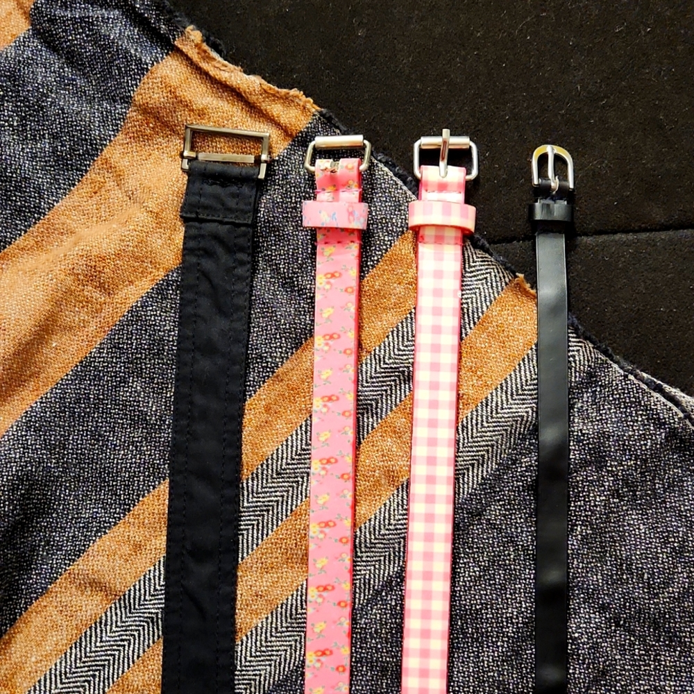 4 used belts printed pink and solid black